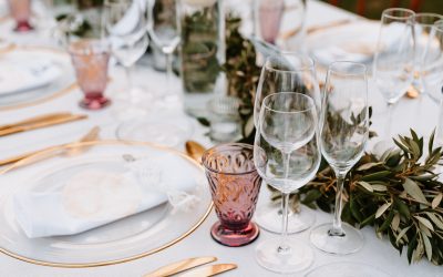 Beautiful Boho Wedding Table Decoration with olive branches and rose drink glasses in Majorca. Selective focus